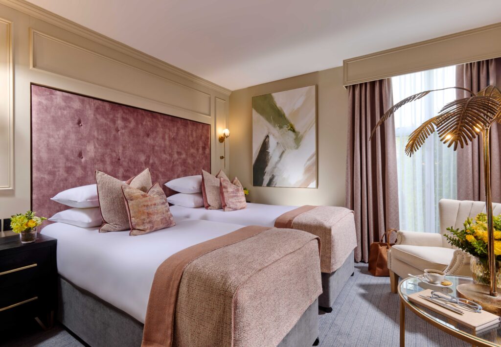 Elegant garden view twin room at Ariel House Dublin with plush beds, soft pink furnishings, and natural light in Ballsbridge