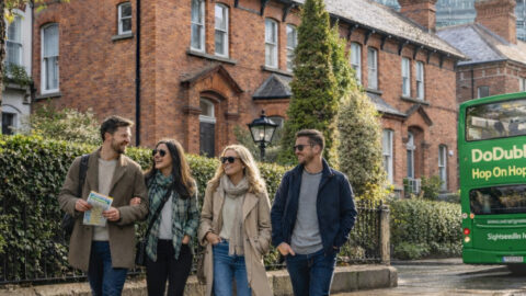 Group of friends exploring Dublin streets near Ballsbridge with sightseeing bus