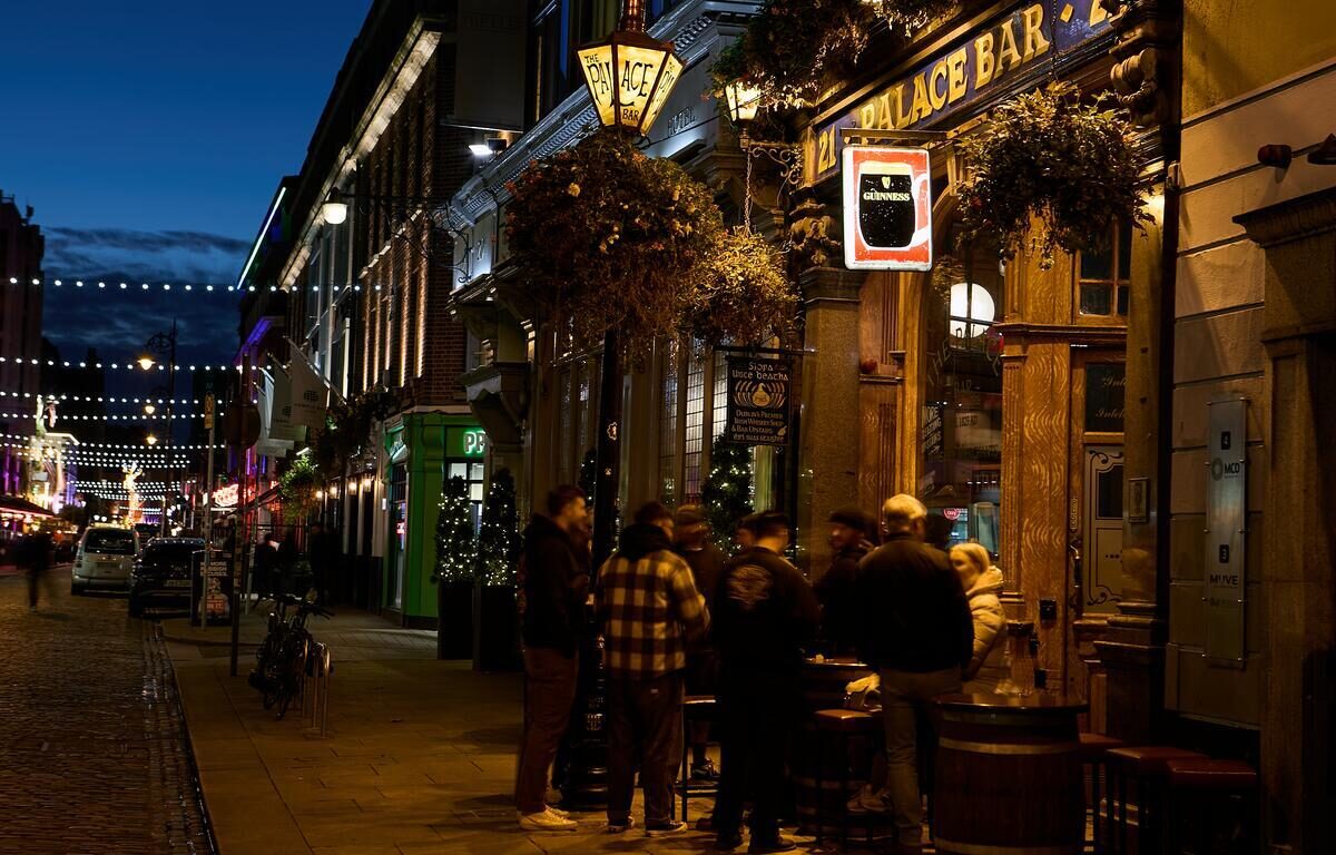 People outside The Palace Bar in Dublin at night enjoying nightlife near Ariel House