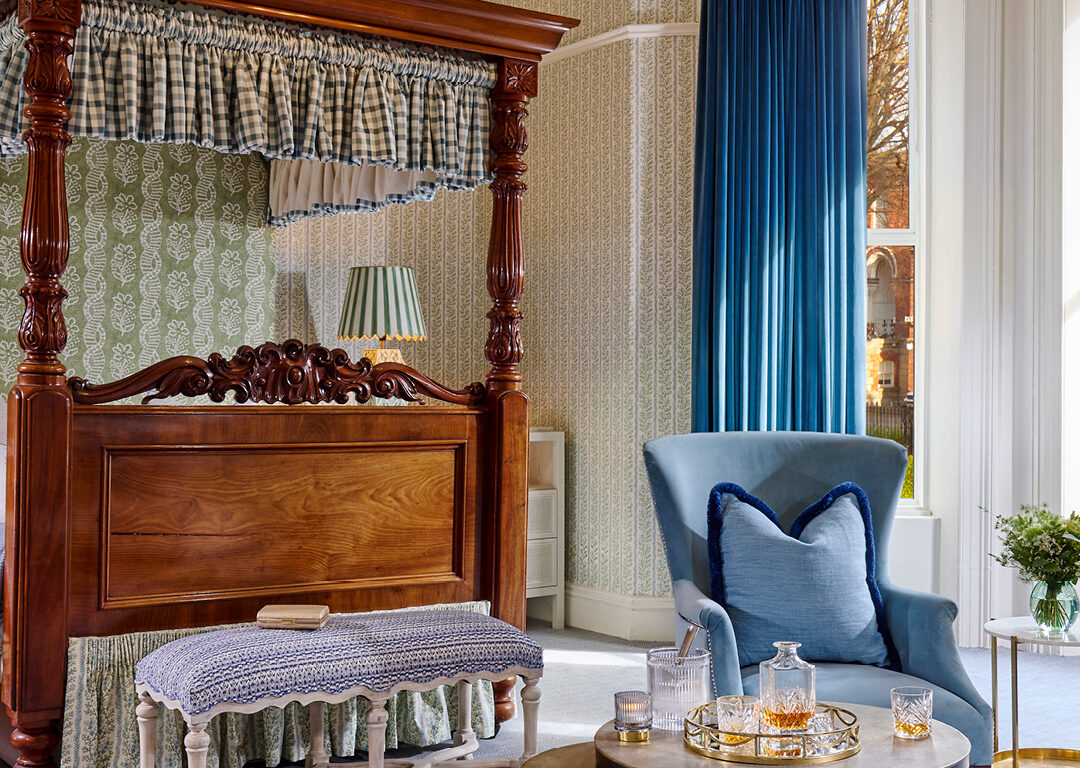 Luxurious junior suite at Ariel House Dublin with canopy bed, chandelier, and elegant seating area