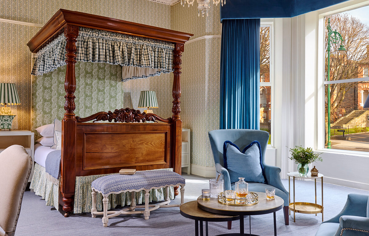 Luxurious junior suite at Ariel House Dublin with canopy bed, chandelier, and elegant seating area