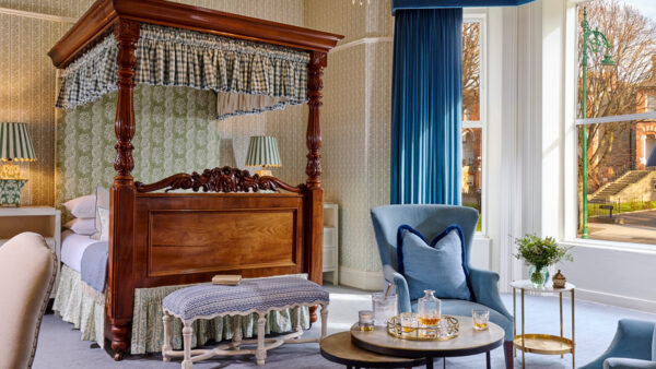 Luxurious junior suite at Ariel House Dublin with canopy bed, chandelier, and elegant seating area