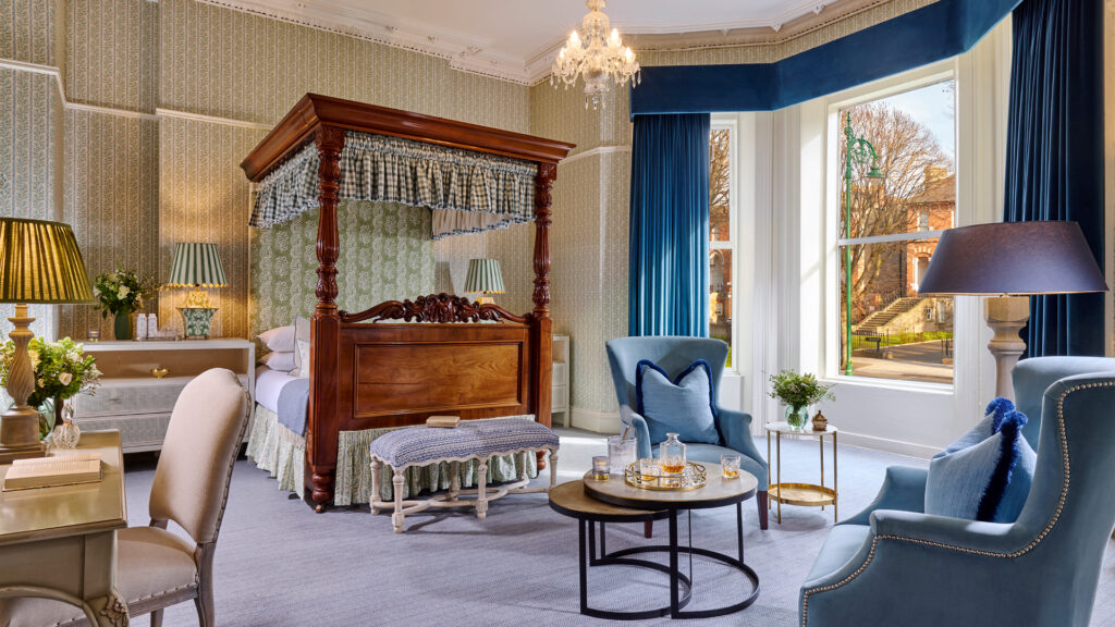 Luxurious junior suite at Ariel House Dublin with canopy bed, chandelier, and elegant seating area