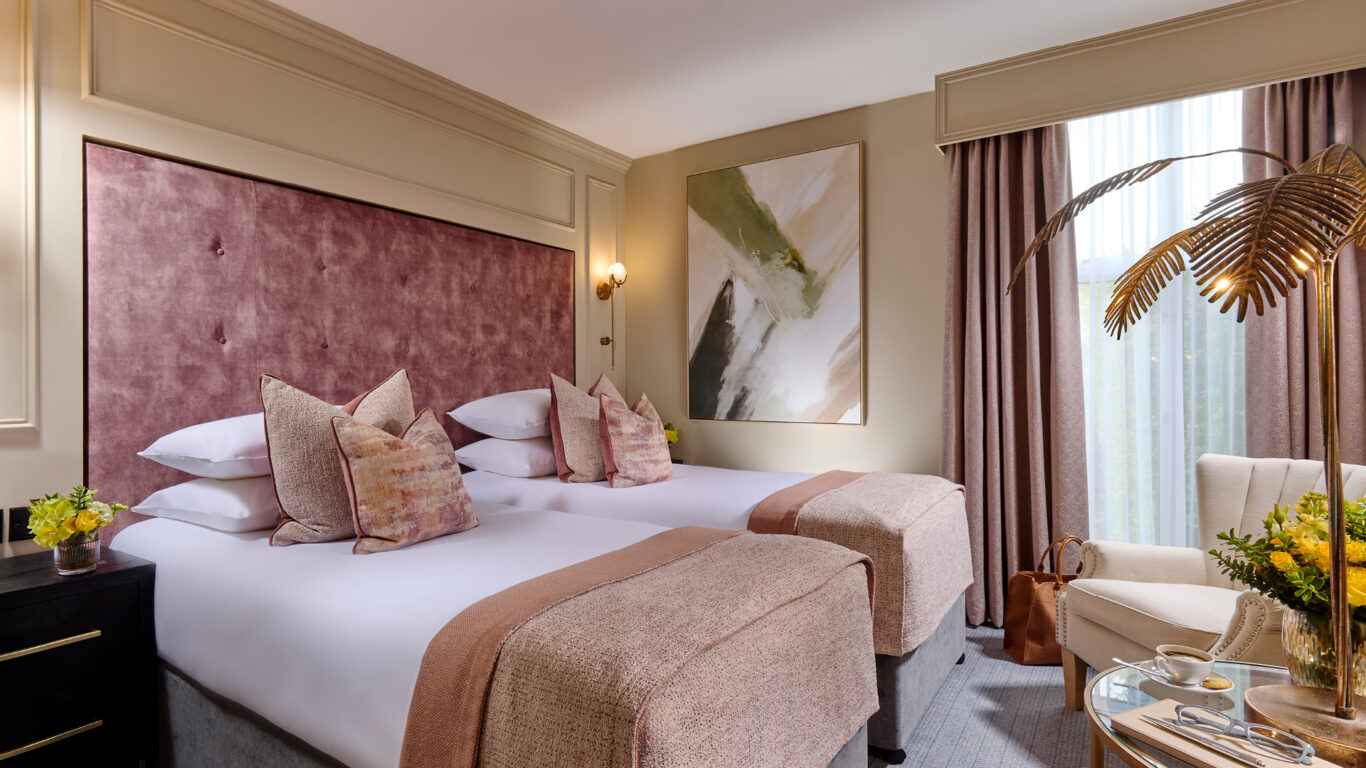 Elegant garden view twin room at Ariel House Dublin with plush beds, soft pink furnishings, and natural light in Ballsbridge