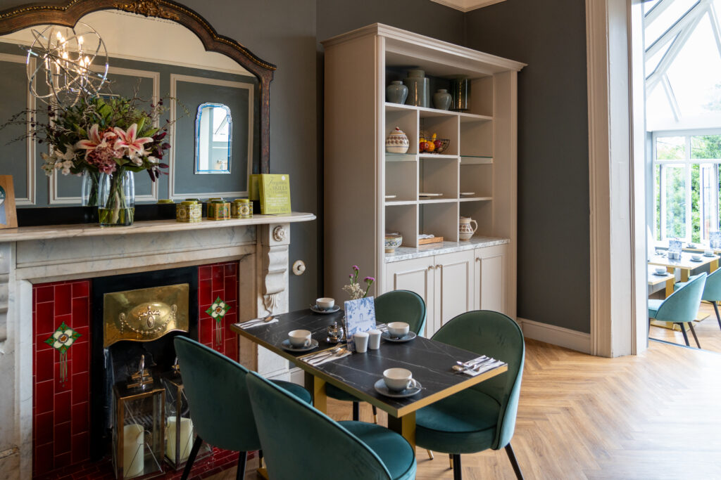 Ariel House Dublin breakfast room with Victorian fireplace and elegant dining tables