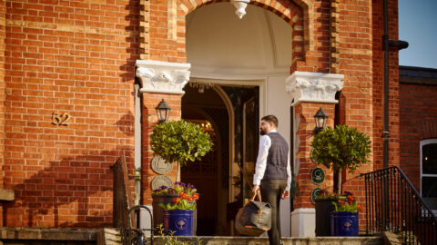 Guest arriving at Ariel House Dublin Georgian entrance in Ballsbridge with luggage