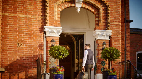 Guest arriving at Ariel House Dublin Georgian entrance in Ballsbridge with luggage