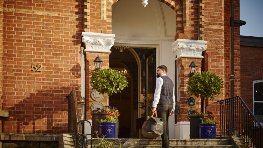 Guest arriving at Ariel House Dublin Georgian entrance in Ballsbridge with luggage
