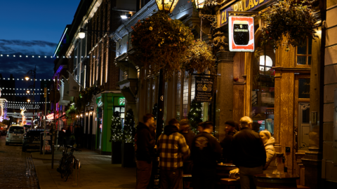People gathered outside the Palace Bar on Fleet Street in Dublin during the festive season on New Year's Eve.